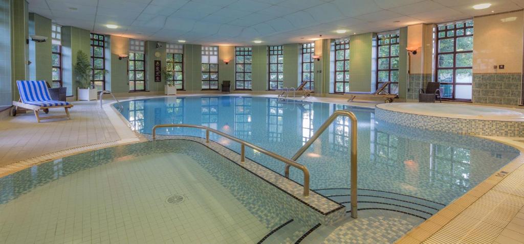 格洛斯特Hilton Puckrup Hall Hotel & Golf Club, Tewkesbury的大型建筑中的大型游泳池