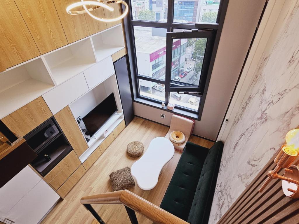 首尔Luxury Apartment near Lotte World的客厅享有高空美景,配有沙发和窗户。