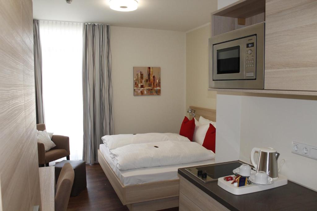 美因河畔法兰克福Prime 20 Serviced Apartments的酒店客房带一张床和一台微波炉