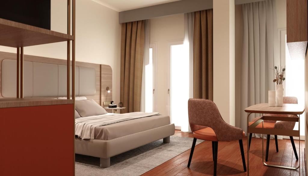 米兰拉斐尔酒店的卧室配有1张床、1张桌子和1把椅子