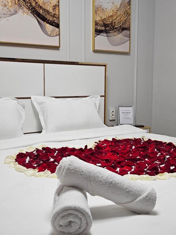 阿拉木图DeLuxe Apartments的一张床上有一大堆红玫瑰