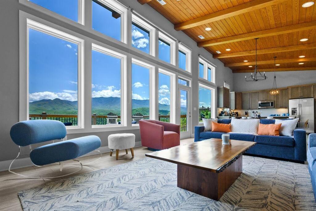 加特林堡Modern Cabin near Smoky Mountain National Park的客厅设有蓝色家具和大窗户