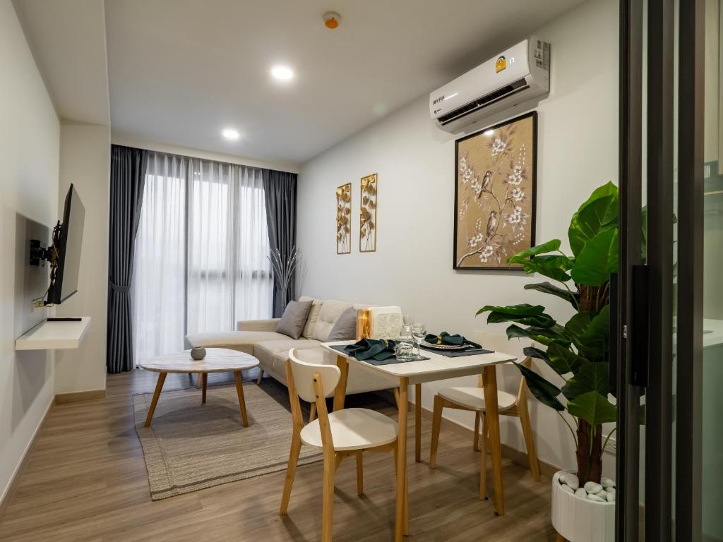 普吉镇Comfortable apartments in Laguna Skypark的客厅配有桌子和沙发