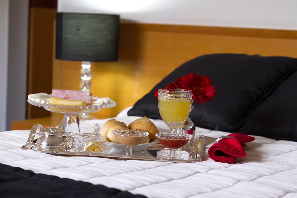 里贝朗普雷托佳纳达酒店的床上的食品和饮料托盘