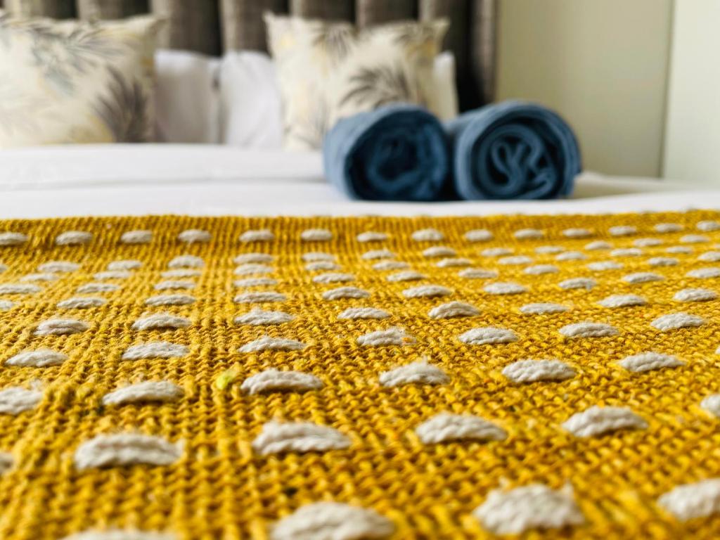 约翰内斯堡Maboneng Modern Style的一张床上,上面有黄色的 ⁇ 萝花毯和玫瑰