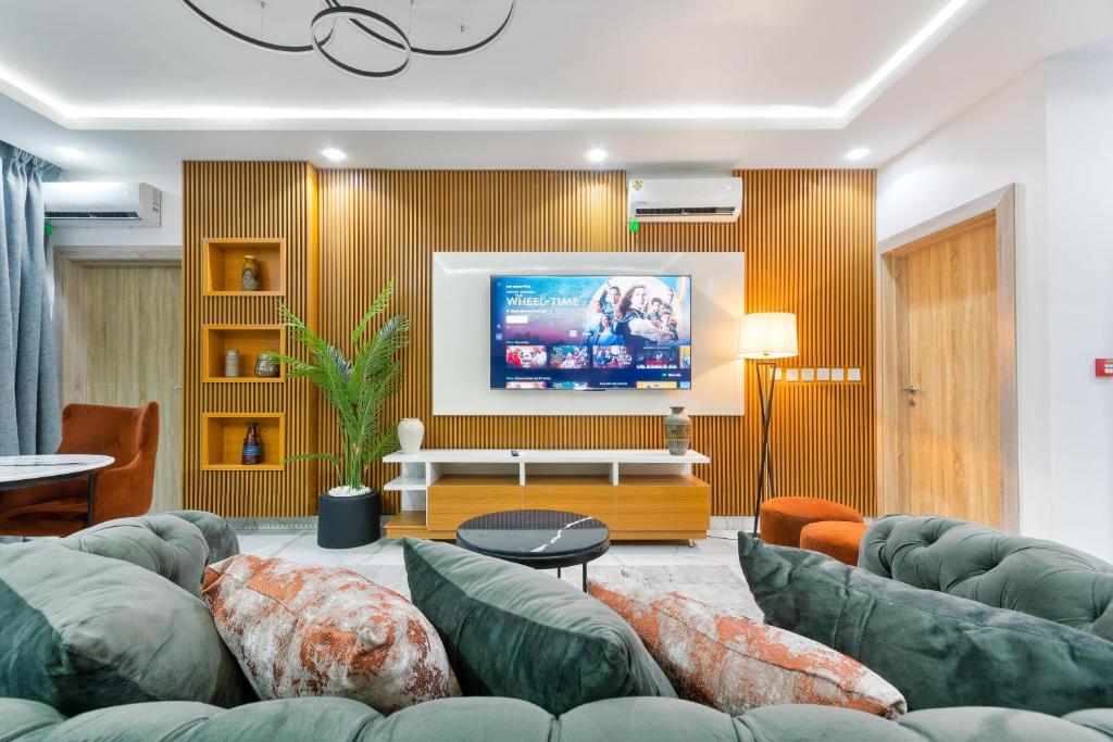 莱基W16 Water Front Apartments的客厅配有绿色沙发和平面电视
