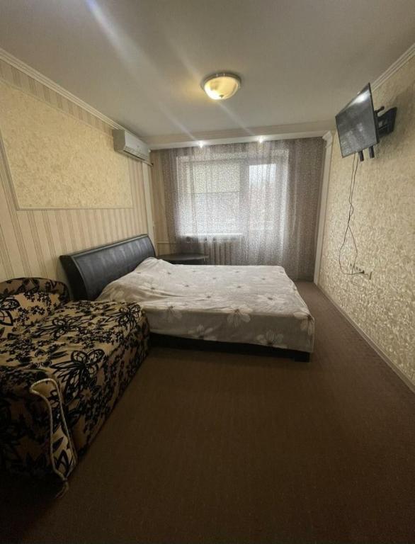 尼古拉耶夫Богоявленский проспект, 43 Апартаменты的一间卧室配有两张床和电视。