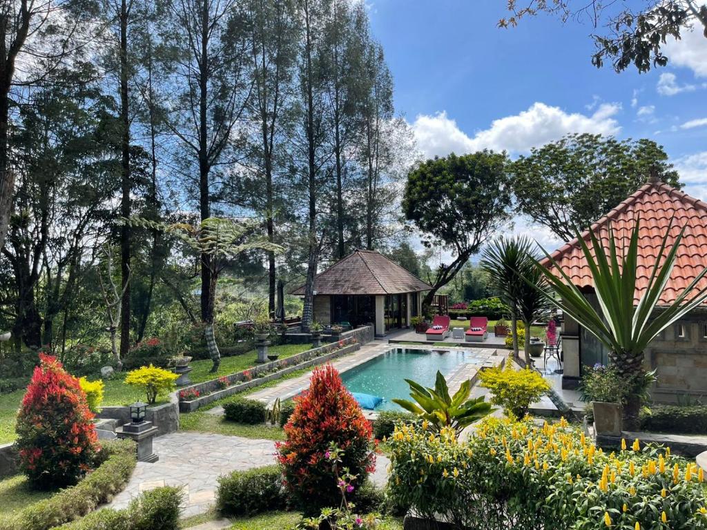 不拉士打宜Balinese Villa in Berastagi的一个带游泳池和凉亭的花园
