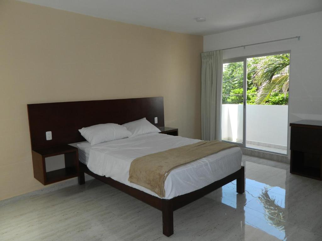博卡德尔里奥ACL Suites的一间卧室设有一张床和一个大窗户