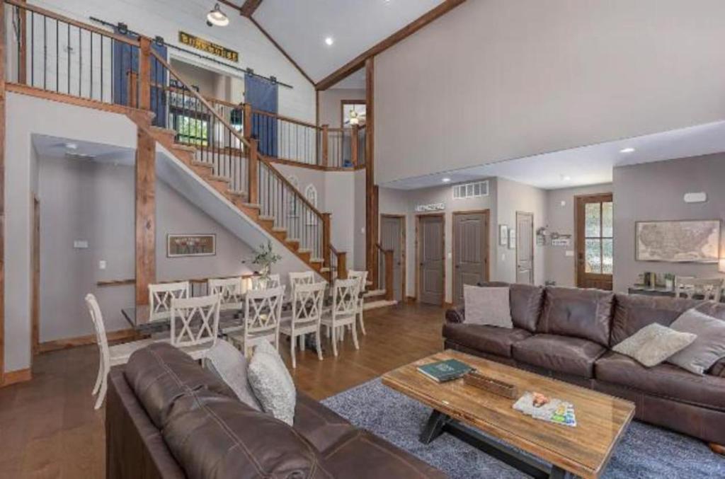 霍利斯特SPACIOUS HAPPY HOME in Branson with 8 BEDS & 6 BATHS的客厅配有沙发和桌子