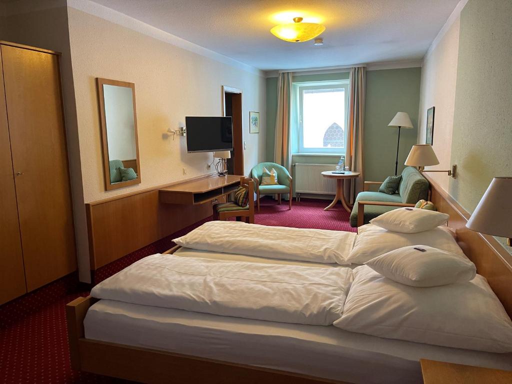 阿本斯贝格Hotel Jungbräu的酒店客房设有一张大床和一台电视。