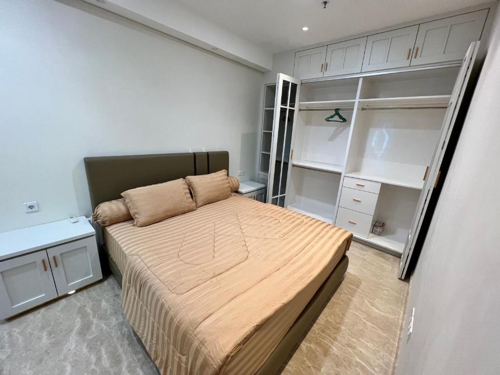 棉兰Apartemen 2BR Podomoro Lincoln Delipark Medan的一间带一张床和衣柜的小卧室