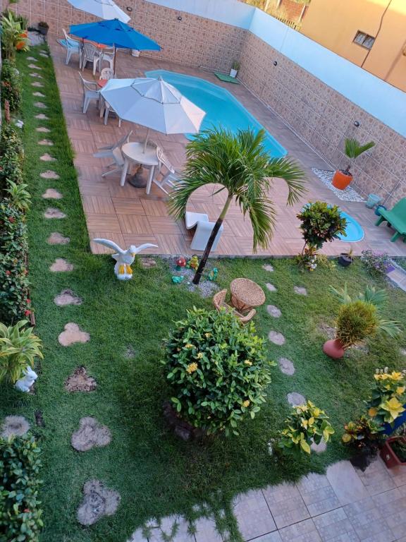普拉亚弗朗西丝Torre do Sol的后院设有游泳池、桌子和遮阳伞