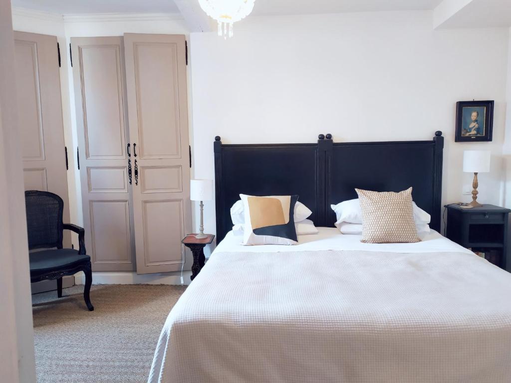 埃梅美美南纬20度公寓的卧室配有一张带白色床单和枕头的大床。