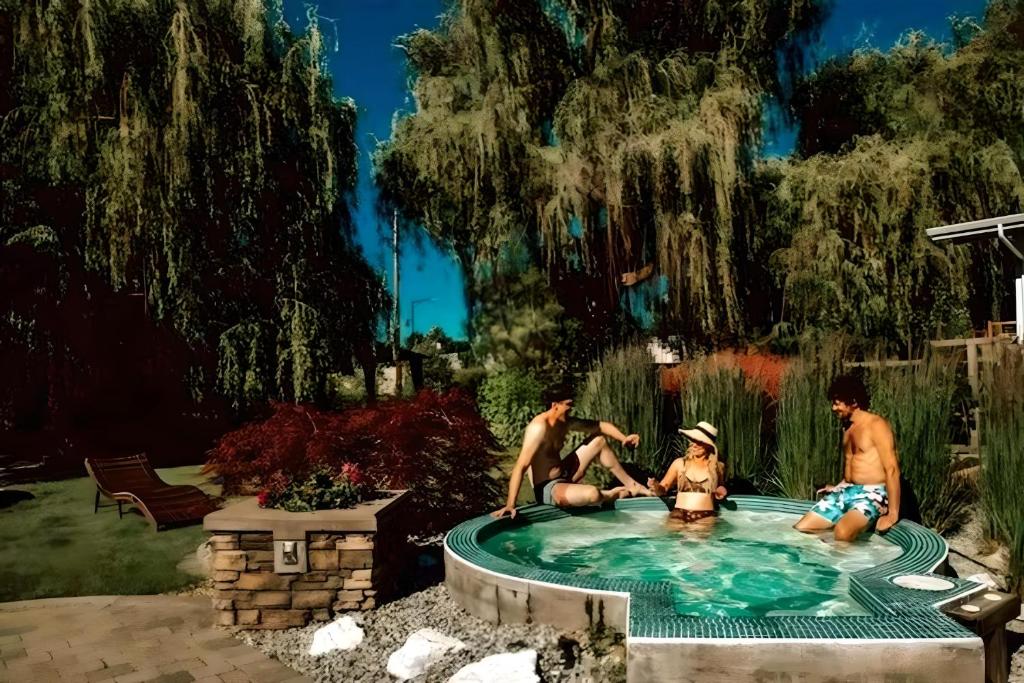 基洛纳Serene Waterfront Escape with Pool, Hot Tub, Pet-Friendly Haven, & Breathtaking Views的一群人坐在游泳池里