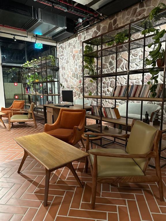 埃拉特Hotel Shoshana - Adults Only的一间商店里带几把椅子和桌子的房间