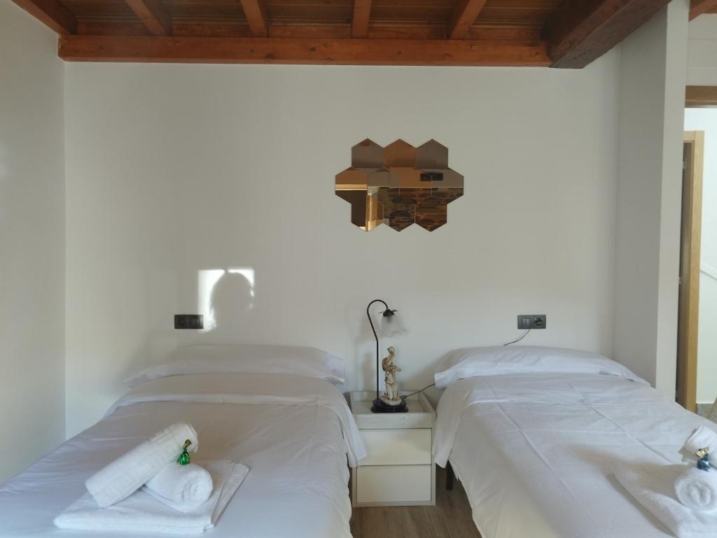 卢戈Lazzaretto vivienda uso turístico的配有2张床的客房内配有白色床单和毛巾
