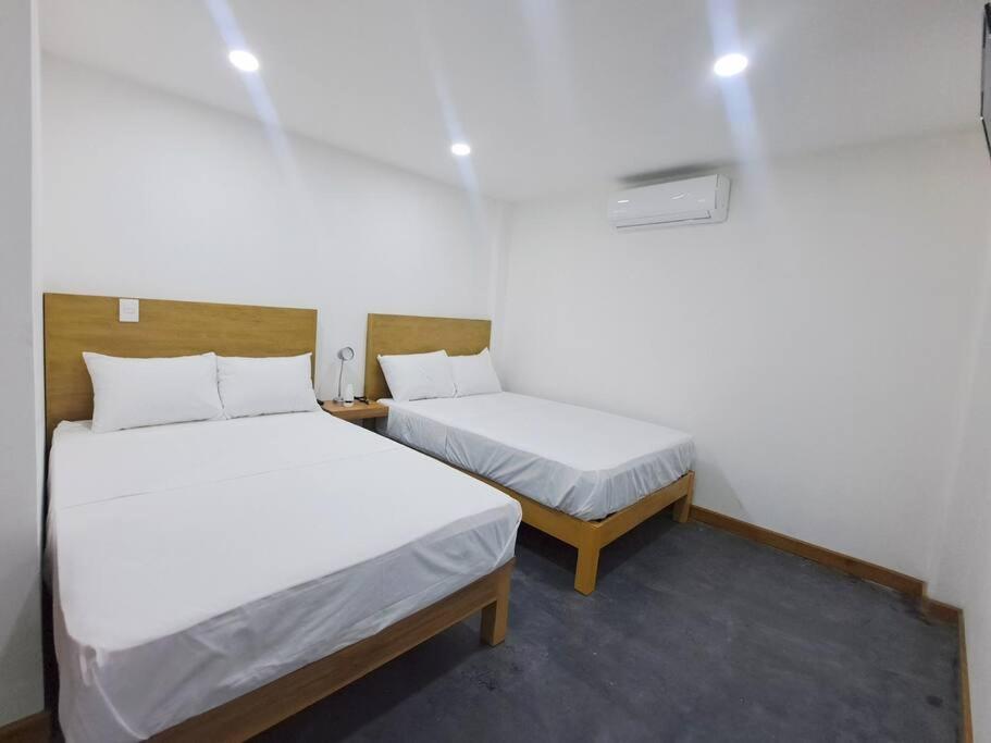 Fortín de las Floreslugar para descansar210的小房间设有两张床,带两张床。