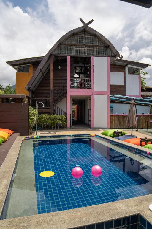 拜县K-Bunk Hostel Pai Walking Street的一座建筑物前的游泳池,有3只飞盘