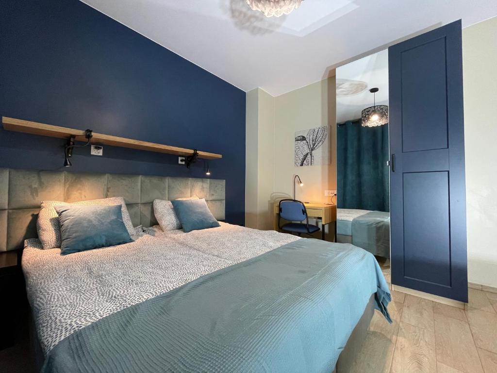 格但斯克Superior Baltea 3 rooms, Beach 800m, AirCondition的一间卧室设有一张大床和蓝色的墙壁