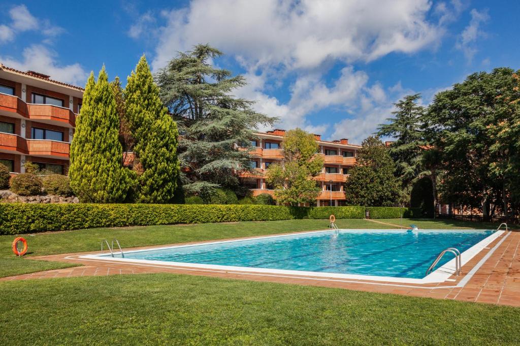 科尔百托Checkin Montserrat的一座游泳池,位于一座建筑旁的院子内