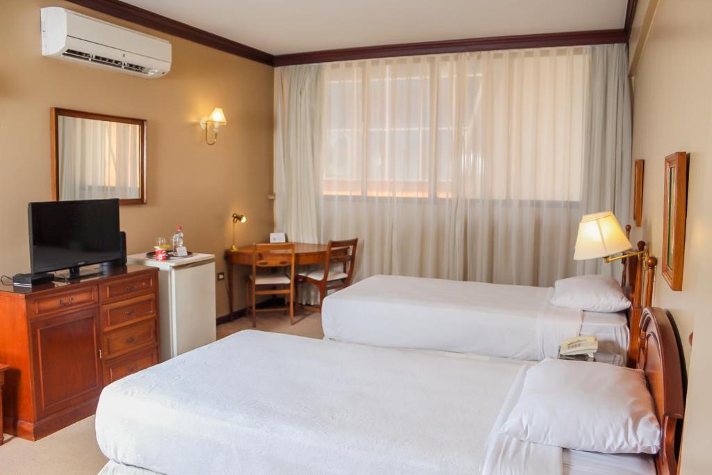 Nobile Suites Excelsior Asuncion客房内的一张或多张床位