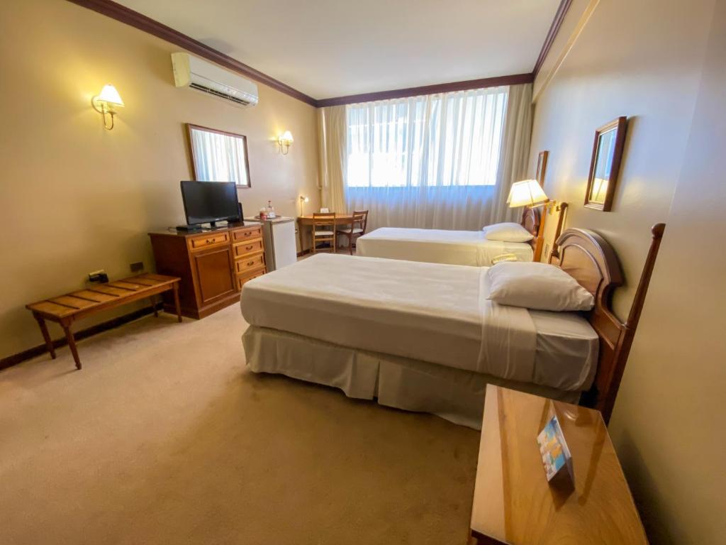 Nobile Suites Excelsior Asuncion客房内的一张或多张床位