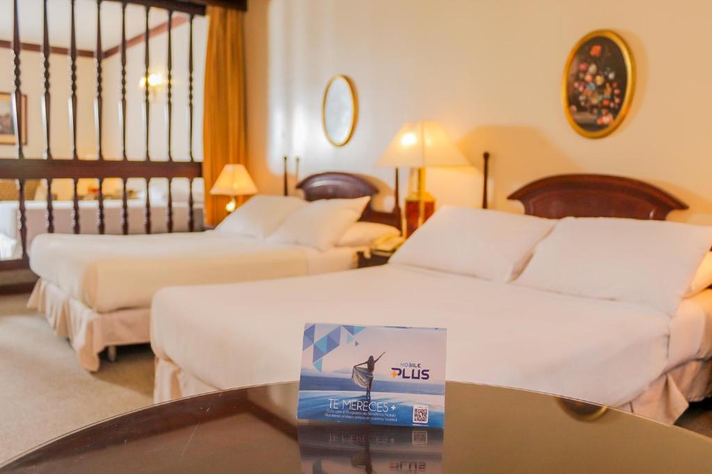 Nobile Suites Excelsior Asuncion客房内的一张或多张床位