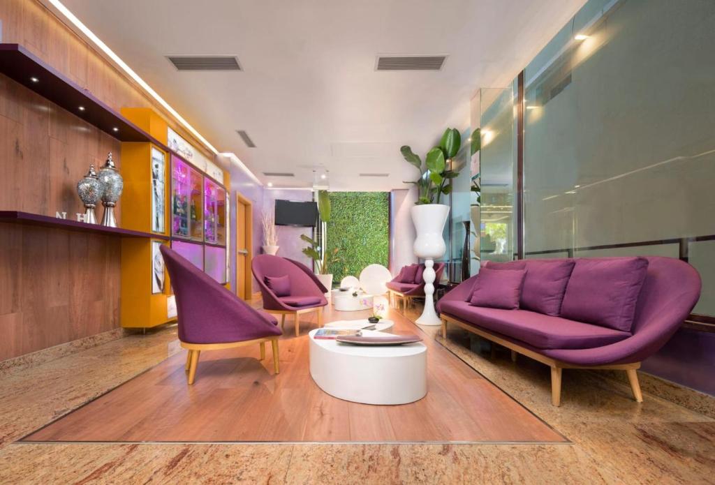 奥伦塞NH奥伦塞酒店的客厅配有紫色椅子和紫色沙发