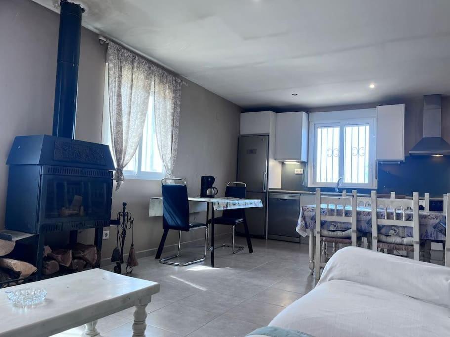 Finca Aideta- casa confortable con barbacoa的带沙发和桌子的客厅以及厨房。