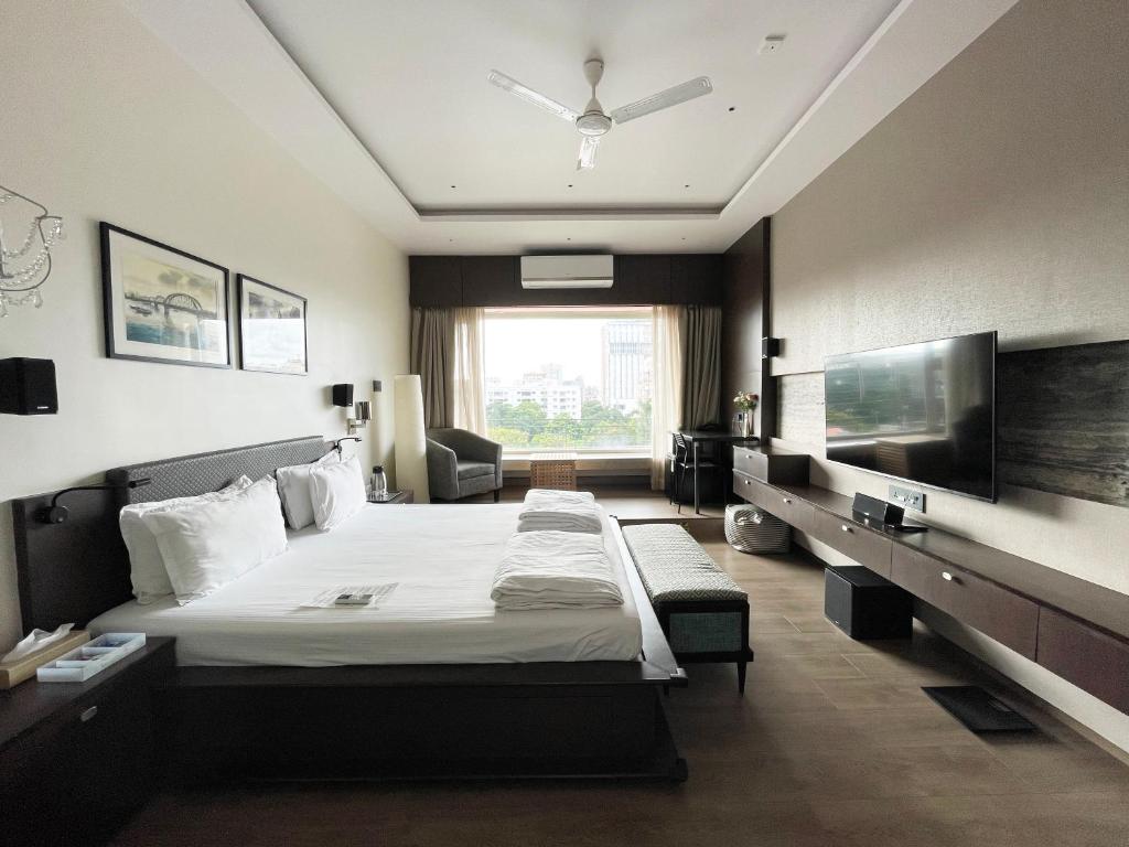 加尔各答城中心住宿加早餐旅馆的酒店客房设有一张床和一个大窗户