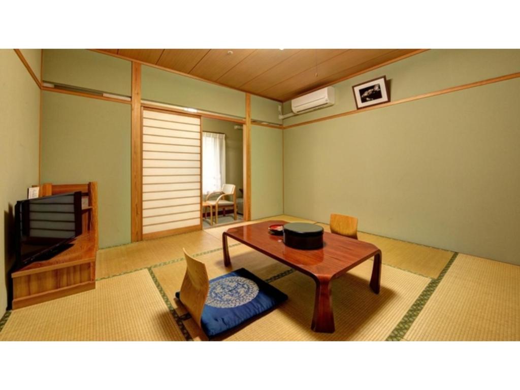 松江市Yuuai Kumanokan - Vacation STAY 27571v的客厅配有桌子和电视