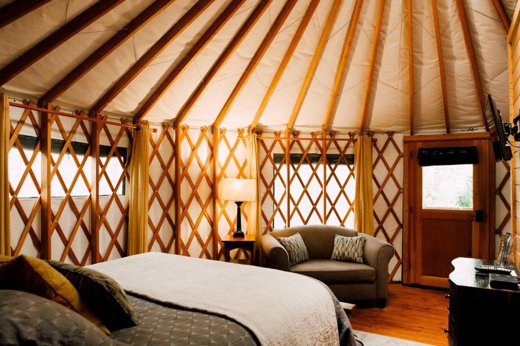 布赖森城Tuckaseegee @ Sky Ridge Yurts的蒙古包内带一张床和椅子的房间