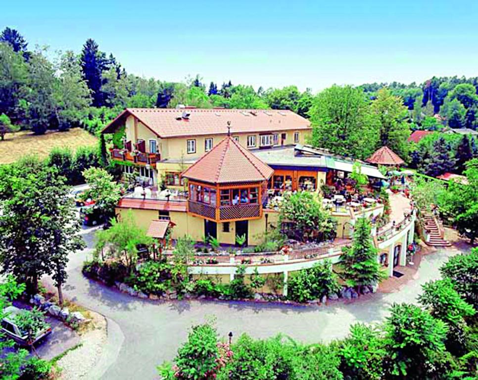 格拉茨Hotel Restaurant - Häuserl im Wald Graz的享有大房子的空中美景,享有河流美景