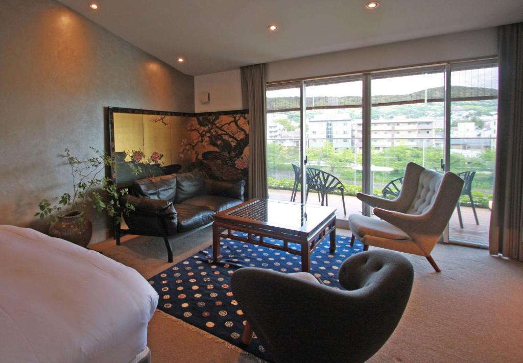 京都京都葵酒店的一间卧室配有床和椅子,一间客厅