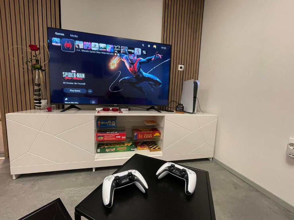 克拉尼斯卡戈拉Apartma Devs的客厅里一台带两个视频游戏控制器的电视