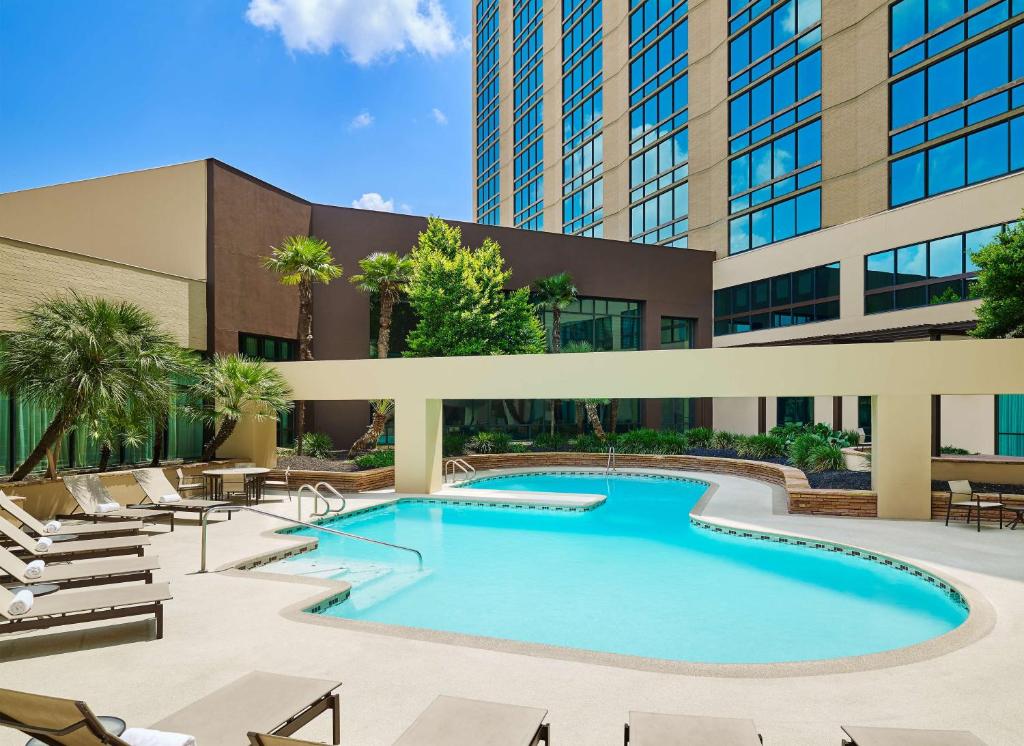 圣安东尼奥DoubleTree by Hilton San Antonio Airport的建筑物前游泳池的图像