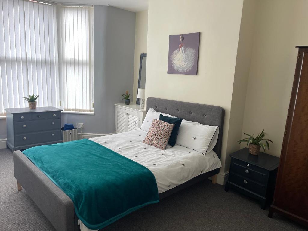利物浦Marks Place的一间卧室配有一张带蓝色毯子的大床