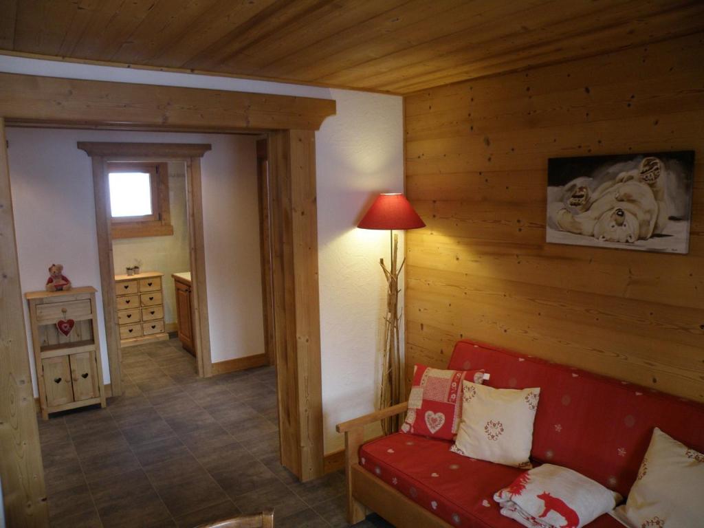 莱热Appartement Les Gets, 3 pièces, 5 personnes - FR-1-671-92的客厅配有红色的沙发和灯具