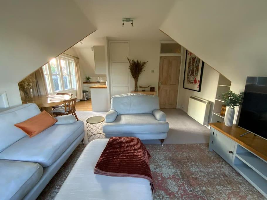法纳姆Ipsley Lodge Apartment Surrey Hills的带沙发和电视的客厅