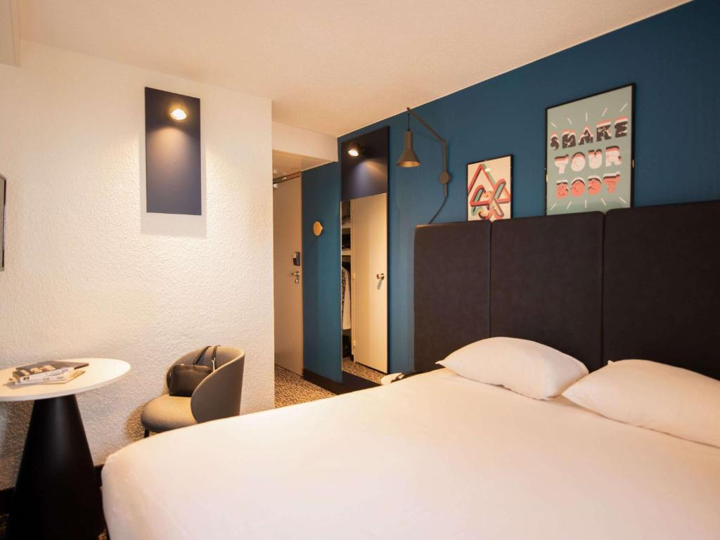 巴黎巴黎托尔比亚克宜必思酒店的配有一张床和一把椅子的酒店客房