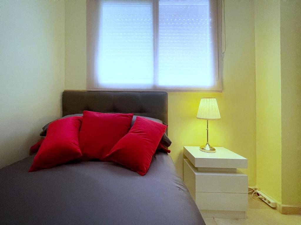 帕特纳Work and Rest Away From Home的一间卧室配有一张带红色枕头的床和窗户