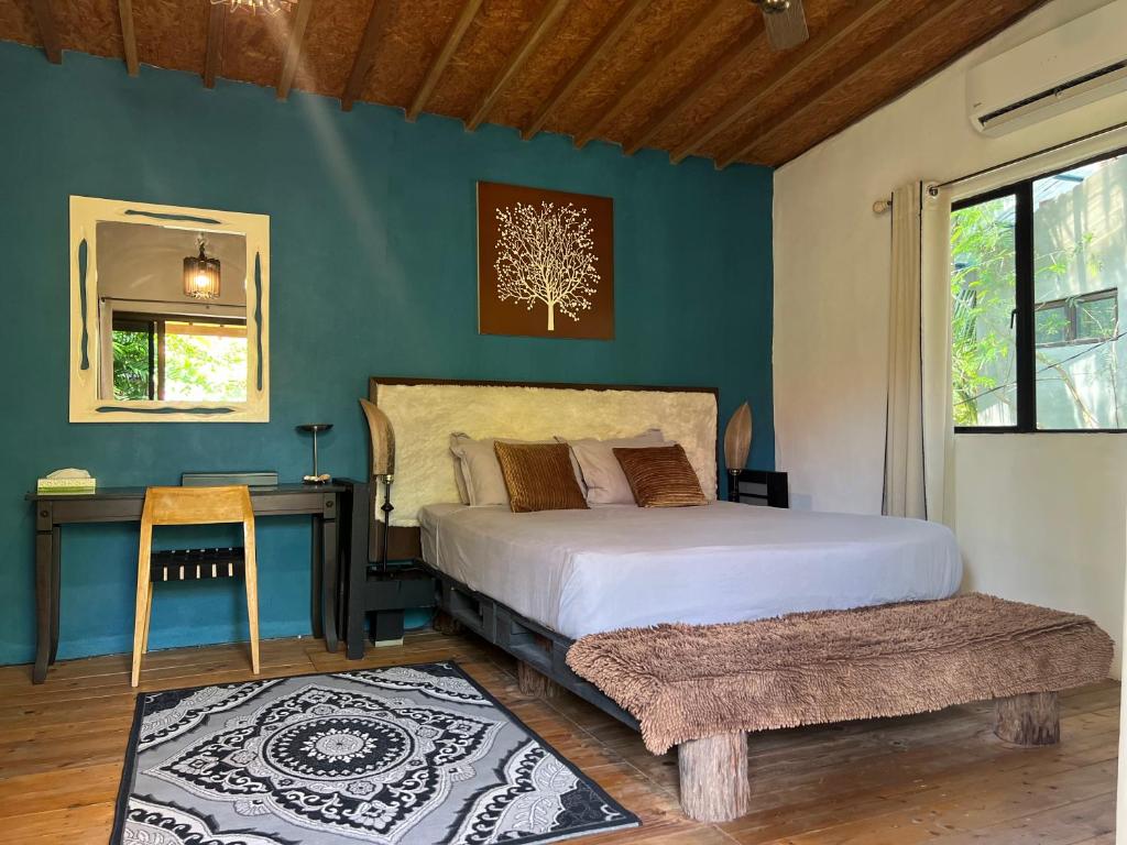 丹绒鲁Eagleye Langkawi的一间卧室配有一张床、一张桌子和一个窗户。