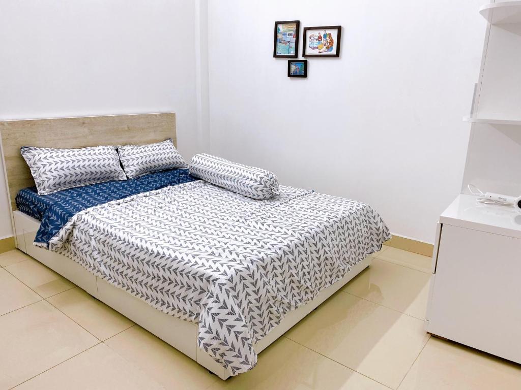 胡志明市SAIGONESE Studio的一间卧室配有一张带黑白色棉被的床