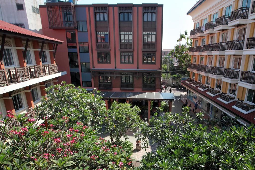 曼谷Rambuttri Village Plaza - SHA Extra Plus的享有一座树木和鲜花的建筑的顶部景色
