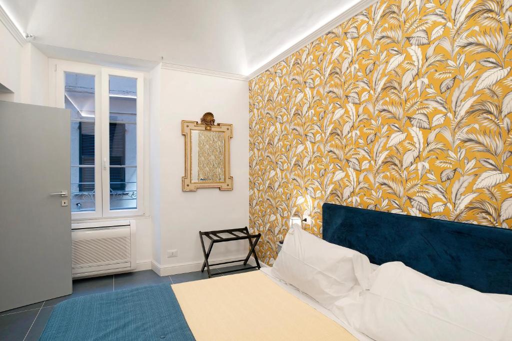 阿拉西奥Loft 42的一间卧室配有一张床,墙上贴有壁纸