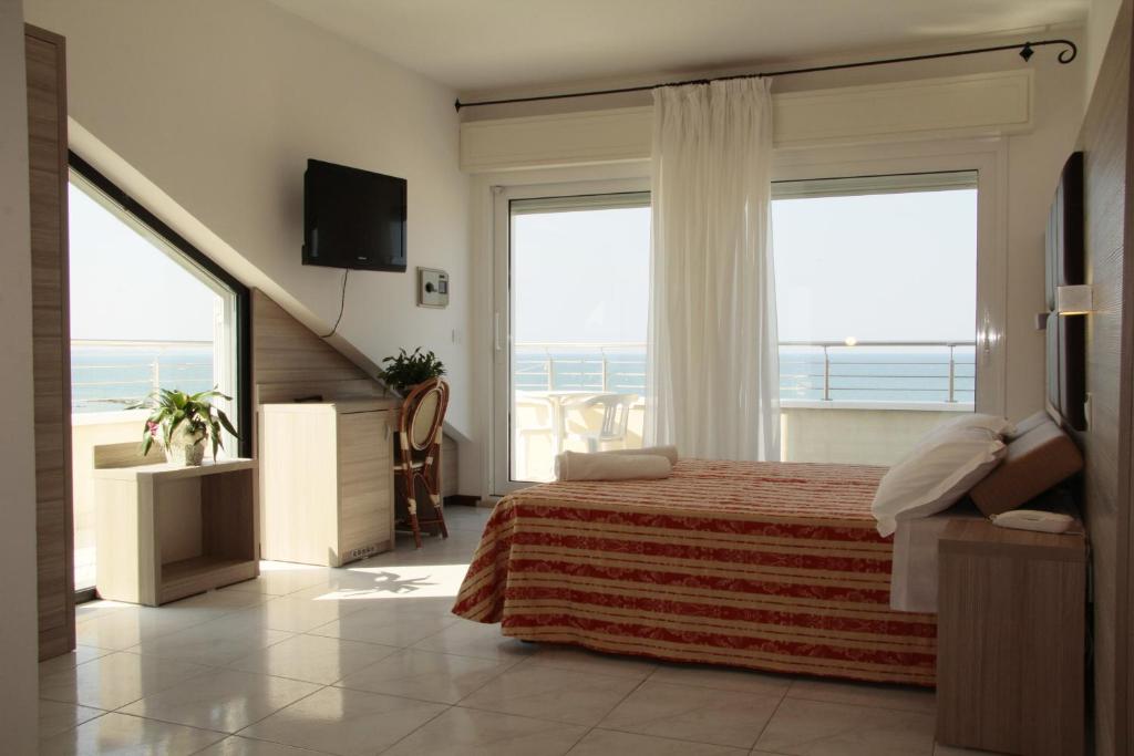 卡托利卡贝尔维尤酒店的一间卧室设有一张床,享有海景