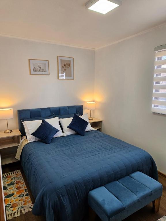圣地亚哥Guest House Club Hípico的一间卧室配有蓝色的床和蓝色的毯子