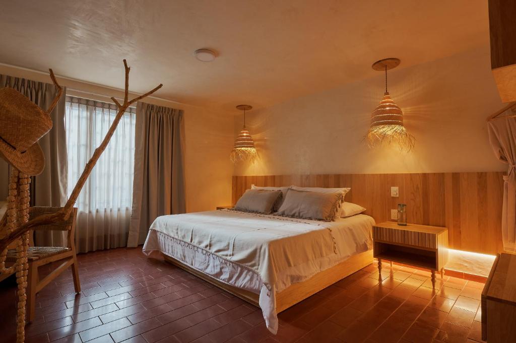 瓦哈卡市Hotel Materia的一间卧室配有一张床和两个吊灯