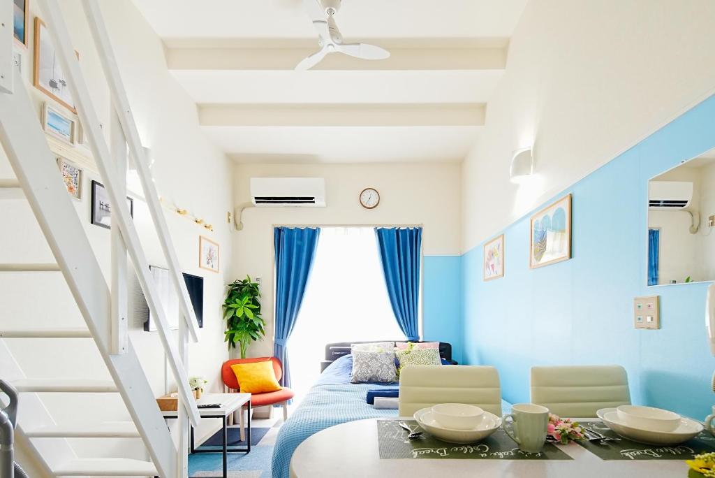 东京SC Heights 101的一间拥有蓝色墙壁、一张床和一张桌子的房间
